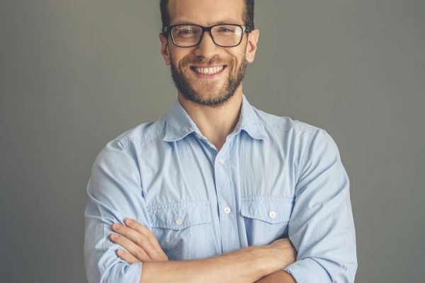 Handsome young businessman in shirt and eyeglasses.